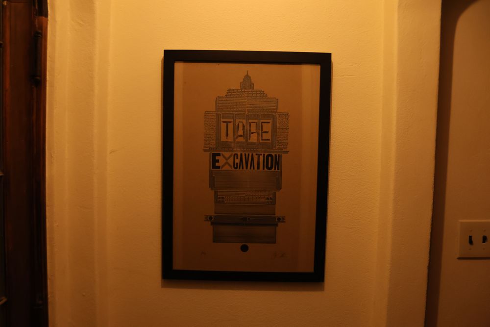 a letterpress print of the artwork from Licher's Tape Excavation, signed and numbered at the bottom, framed and hung on the wall
