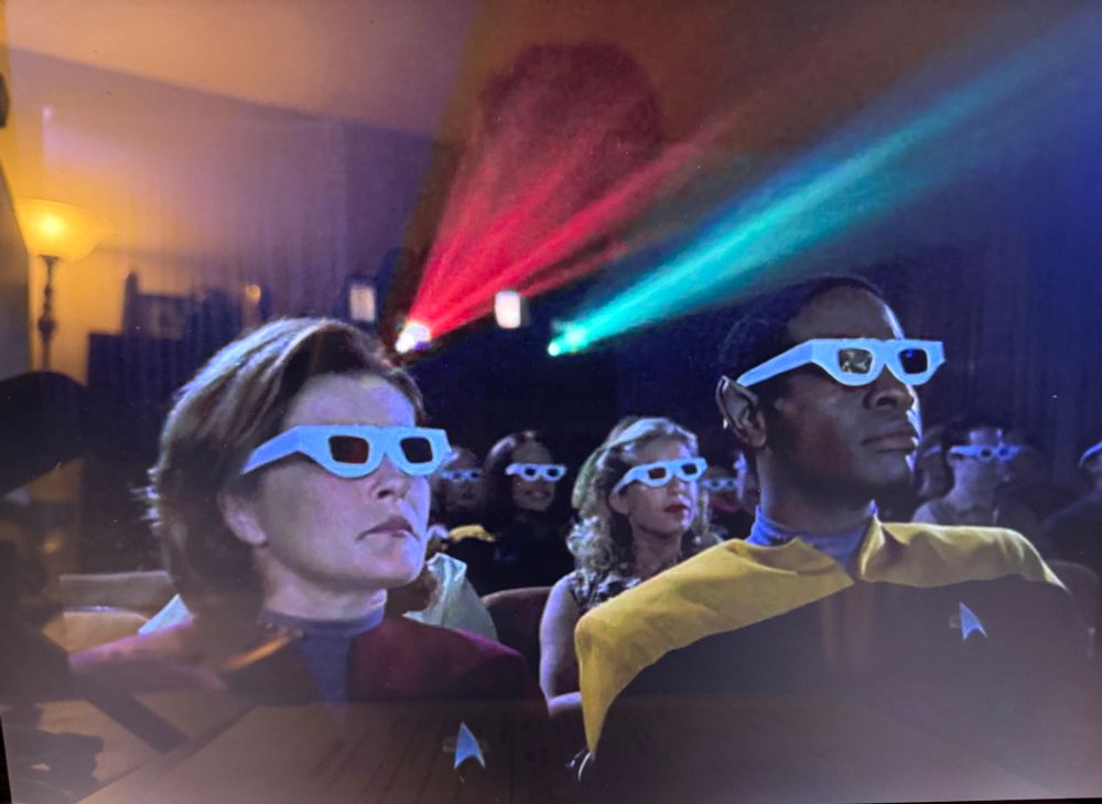 Janeway and Tuvoc watching a movie with 3D glasses.