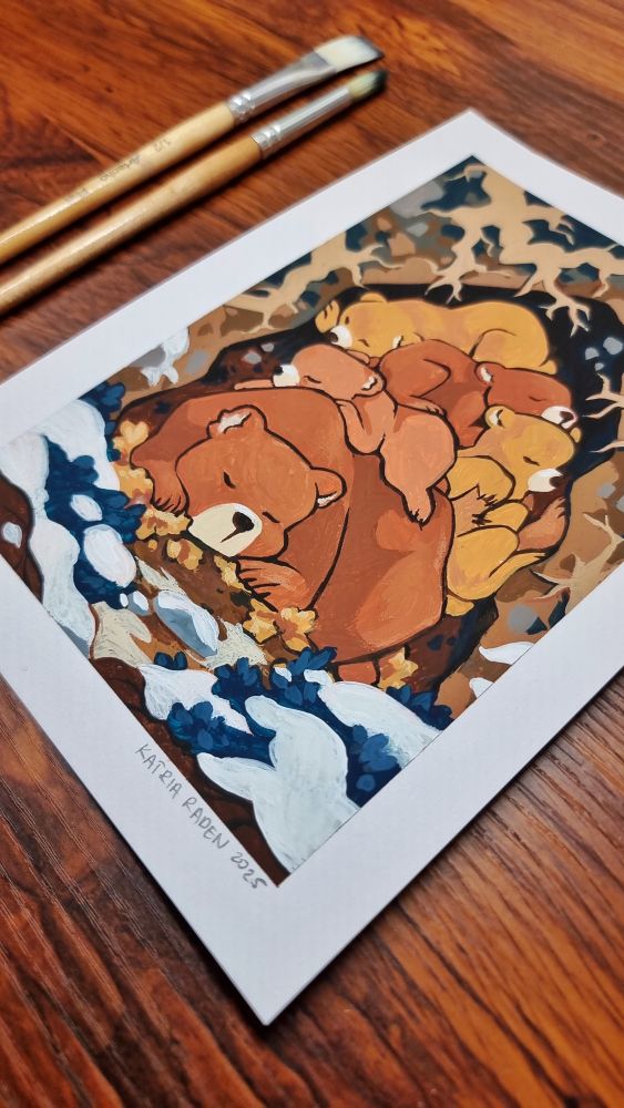 close up photo of a bear family (mama bear and four cubs) sleeping huddled together in a cave