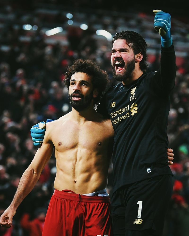 Alisson celebrates with Mo Salah.