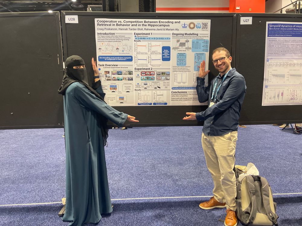 craig (right) and raheema (left) point to their poster