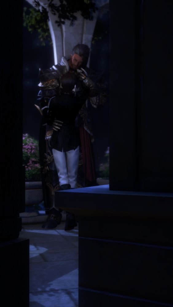 A screenshot of Woefulwillow and I's ocs, Morgan and Krieg. Morgan is a pale, dark haired Midlander Hyur with blue eyes. Krieg is a tan, dark haired Highlander Hyur with amber eyes. Krieg is dressed in ornate dark armor that has gold and red accents. Morgan is dressed in a black suit jacket, white pants, and tall dark boots. Their attire suggests they're at some formal event.

They're standing together on a balcony at night, the stars glowing faint in the background. But the view of them is slightly distant and partially obscured by pillars - as though one were walking by and accidentally spotted them sharing a private moment.

Krieg is slightly pressed up against a marble pillar as Morgan stands in front of him, pressed close. His right hand is reaching up to hold the side of Krieg's face, who gladly, always, leans into the touch. Krieg's left hand gently hold's Morgan's wrist, hoping to keep him there. Meanwhile, Krieg's right hand gently hold's Morgan's waist, supporting the shorter man as he leans back slightly to look up at him.