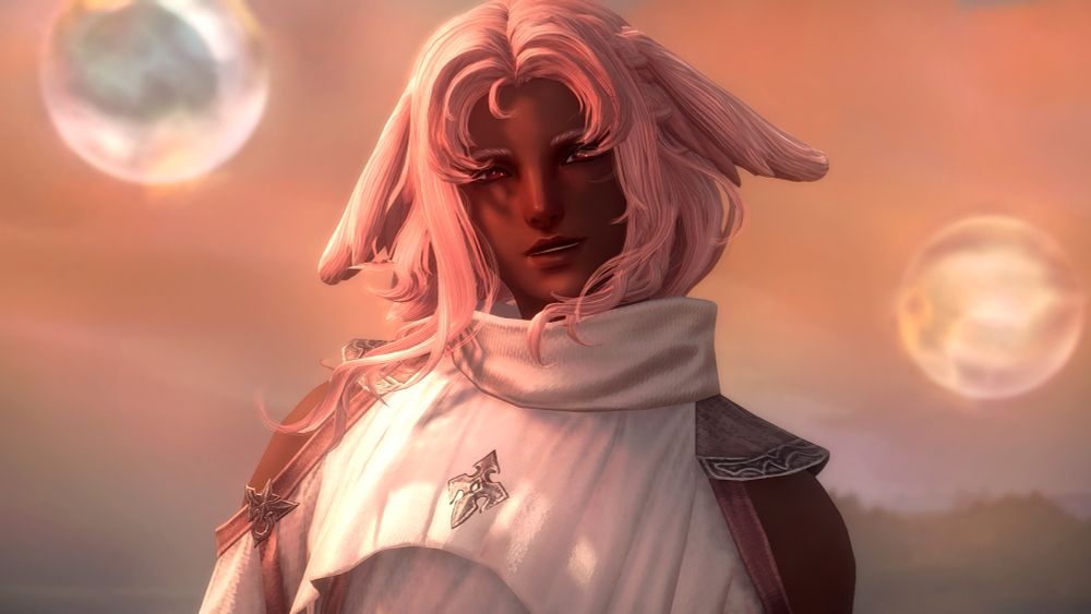 A screenshot of thefinalstar's oc, Niranjana (he/she/they pronouns)

He is a brown Viera with pink hair and red(ish) eyes, dressed in the Asphodelos chiton of healing that is dyed white with pink accents. They're outside in the Occult Crescent region as the sun is beginning to set, casting a soft pinkish/orange hue across the scene. Two large bubbles can be seen floating in the distance