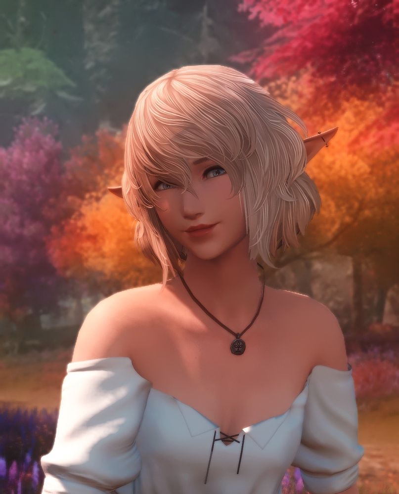 A blonde elezen/elf girl is sitting with purple, orange, and red hued trees behind her. She's wearing an off-the-shoulder white shirt with a Nophica necklace.