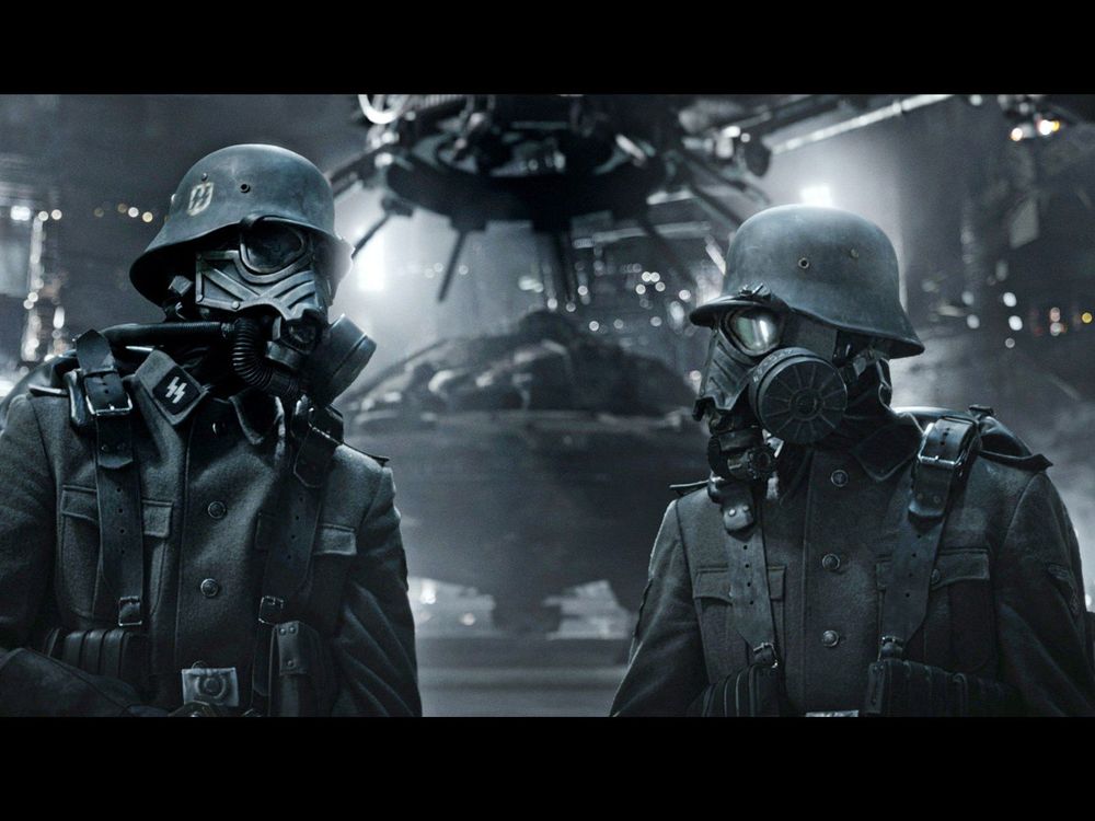 A still from one of the Iron Sky (2012/19) movies.
It shows two Nazi soldiers in SS uniforms and wearing breathing apparatus. They're standing In front of something "spacey".