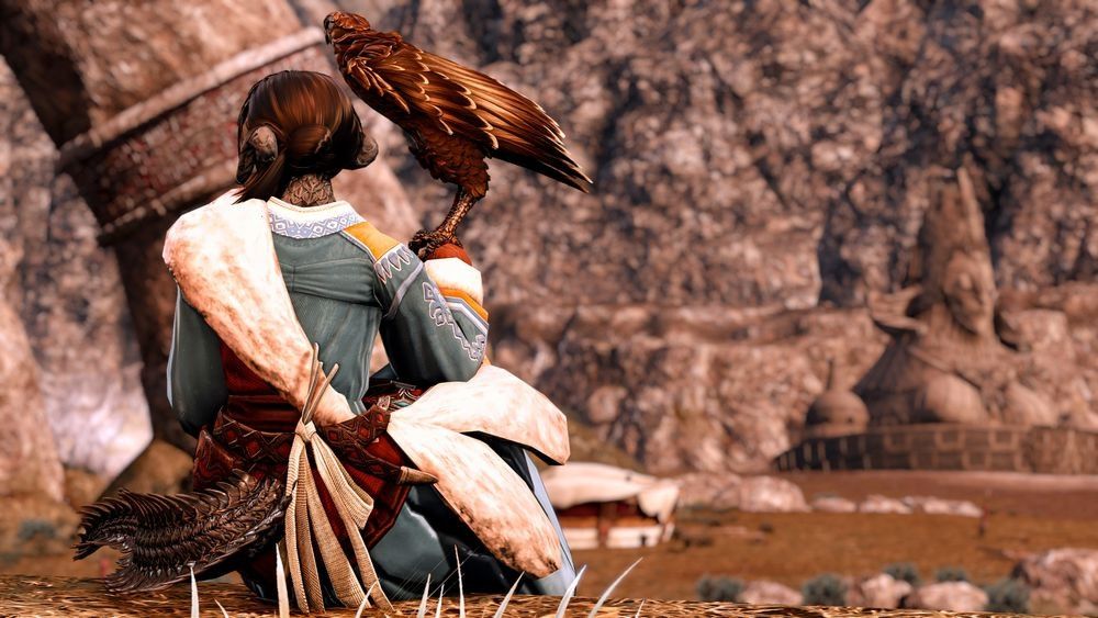 Uyanga Kagon and her eagle, Zaya, sit on a cliff face opposite the Dusk Throne, the camera is positioned behind them. Zaya is perched on Uyanga's mitted right hand. Uyanga looks to the left, towards where the Dawn Throne would be. The sun is setting, bathing the Steppe in a golden light.