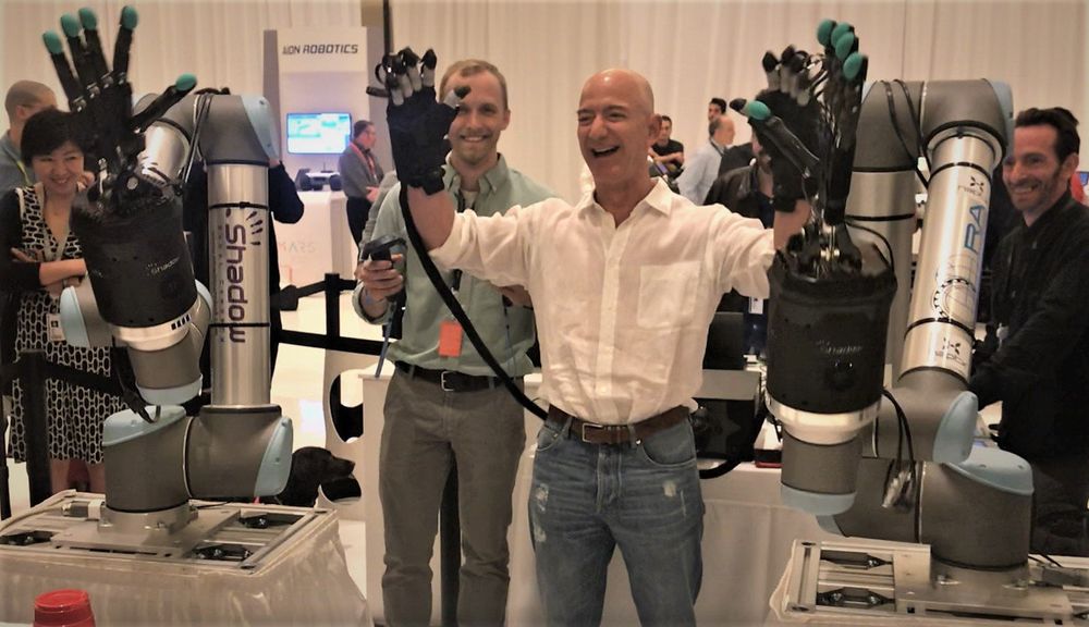 Fascistic billionaire, Jeff Bezos, plays with child-crushing robot hands while laughing maniacally
