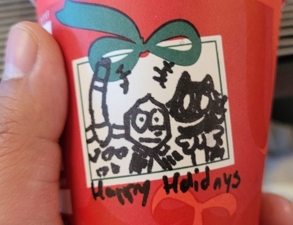 battat jongler and pluey all hastily drawn on a cup, with the words Happy Holidays scrawled on the bottom. I do not support the job im working i hate it here help me