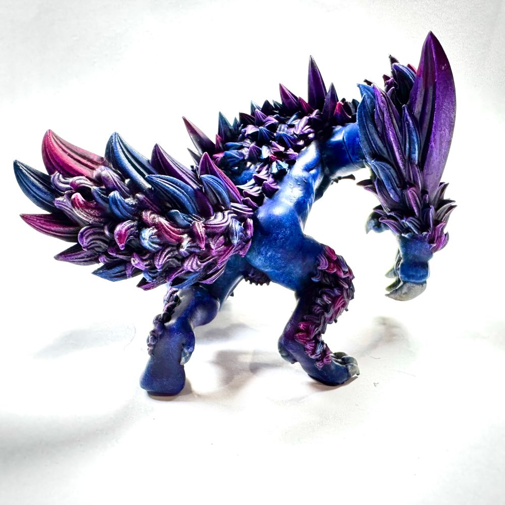Dungeons and dragons wolf miniature painted in blues, purples and magenta tones. 