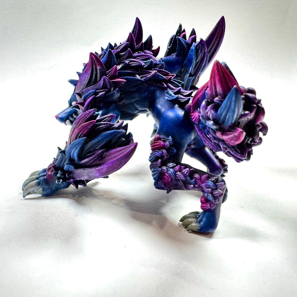 Dungeons and dragons wolf miniature painted in blues, purples and magenta tones. 