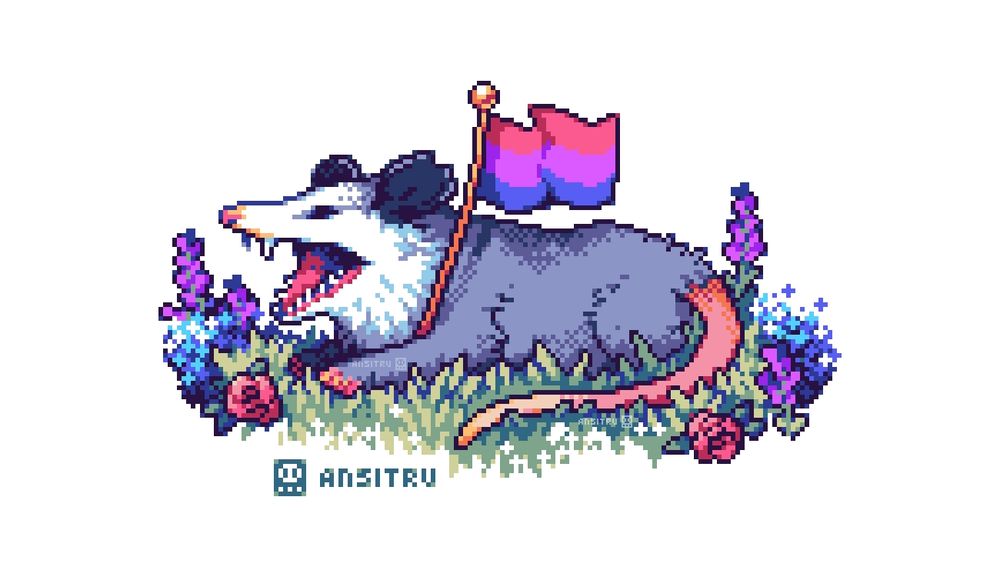 A possum sitting on grassy field, holding the bisexual pride flag. They are surrounded by blue, purple and pink flowers. 