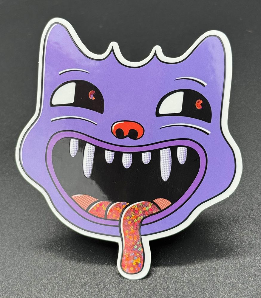 A silly goblin-esque cat with a glittery tongue.