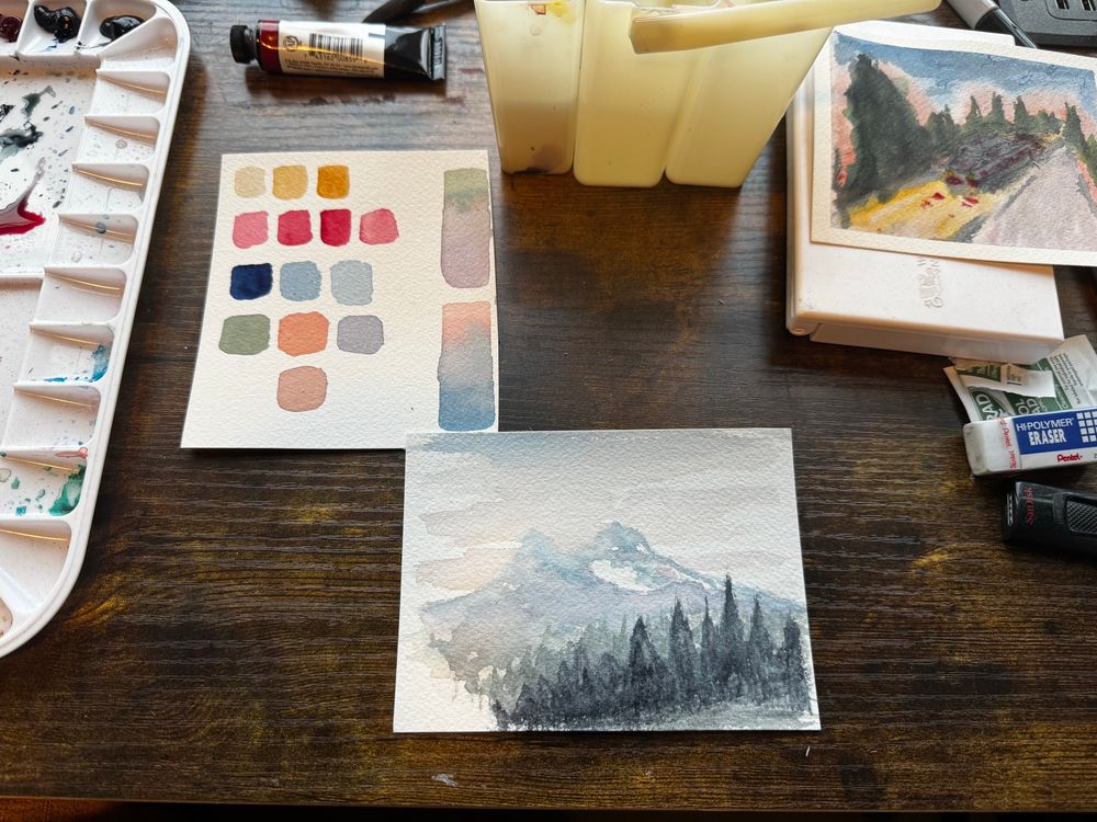 Watercolor landscape of mountains and trees in limited pallet yellow ochre prussian blue, alizarian crimson and payne’s gray