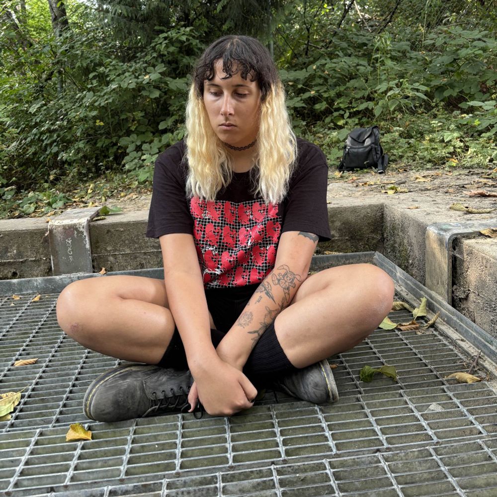 Nish Bae 7 years into her transition. She has blonde ends on her hair and a Jpegmafia shirt