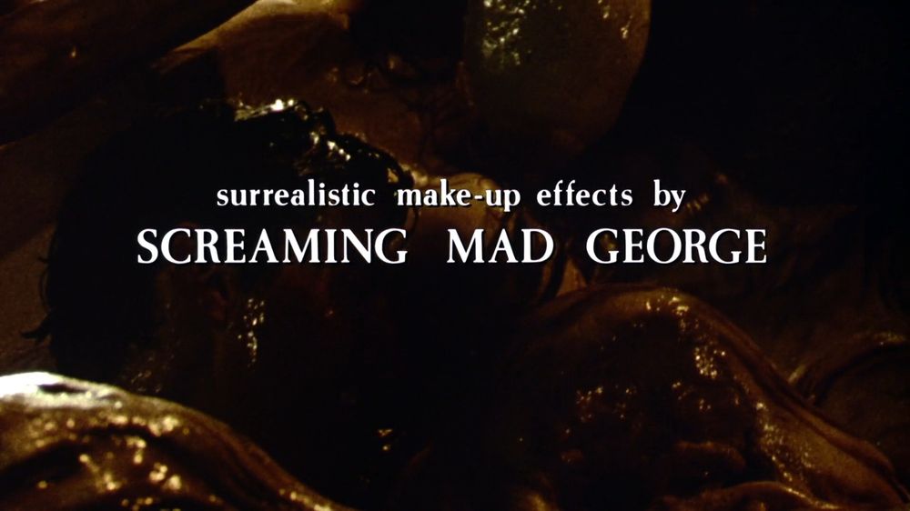 vague unintelligible body horror behind a credit reading "surrealistic make-up effects by screaming mad george"