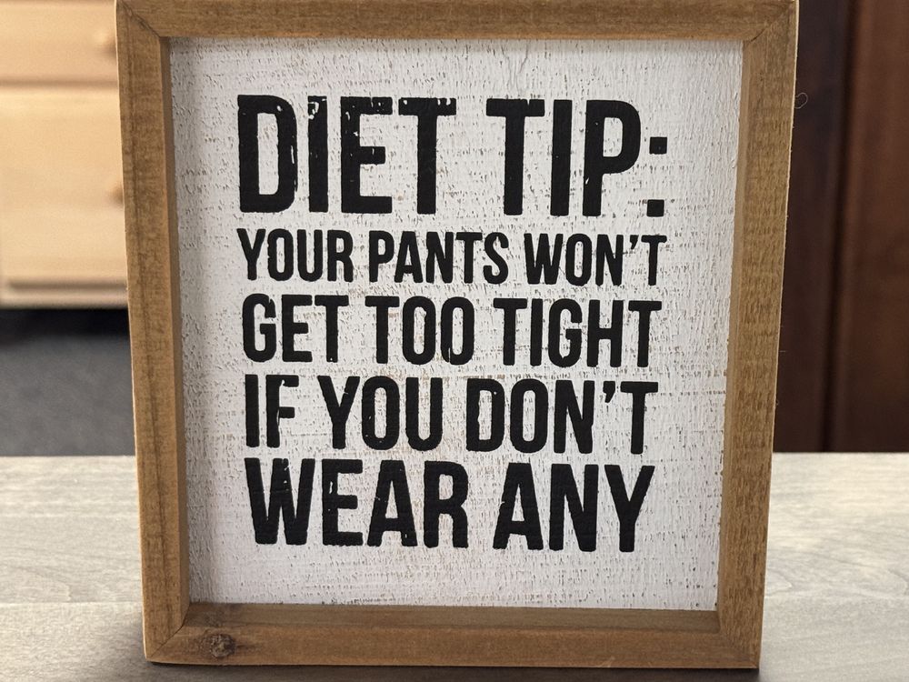 Sign saying: Diet tip: your pants won’t get too tight if you don’t wear any.