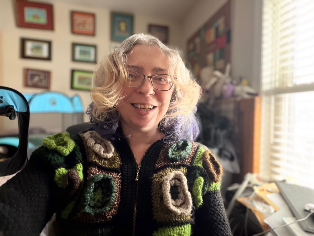 I'm wearing a heavily-textured granny square crocheted sweater and my hair is all big, loose curls. 