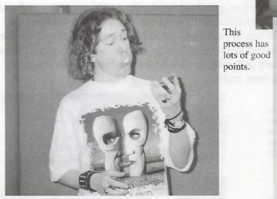 Gavin Tyler in a Division Bell shirt and 1990s bracelets, scarfing a pie.