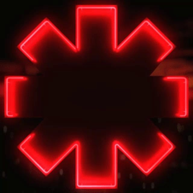 a red neon sign that looks like a medical symbol