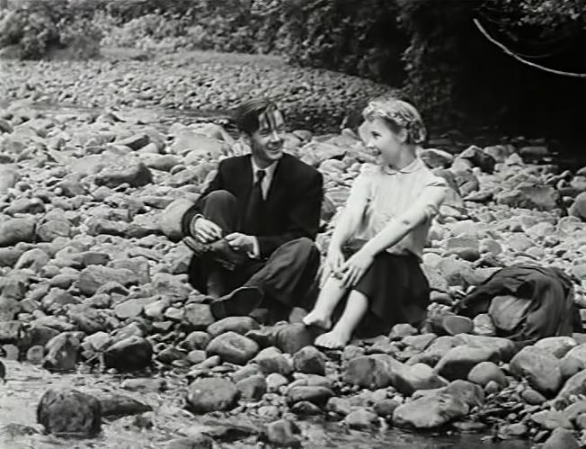 Fulton Mackay and Prunella Scales sitting on the stones of a river bank in Laxdale Hall (1953)