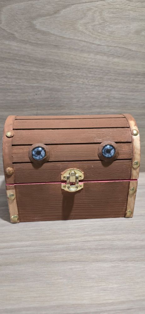 Brown wooden chest with blue eyes
