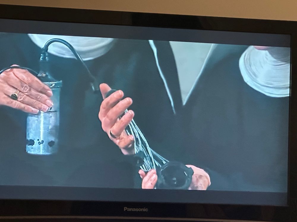 Sisters Margaretta and Sister Berthe holding up car parts in The Sound of Music. Sorry I’m gay and cannot be sure what the car parts are.
