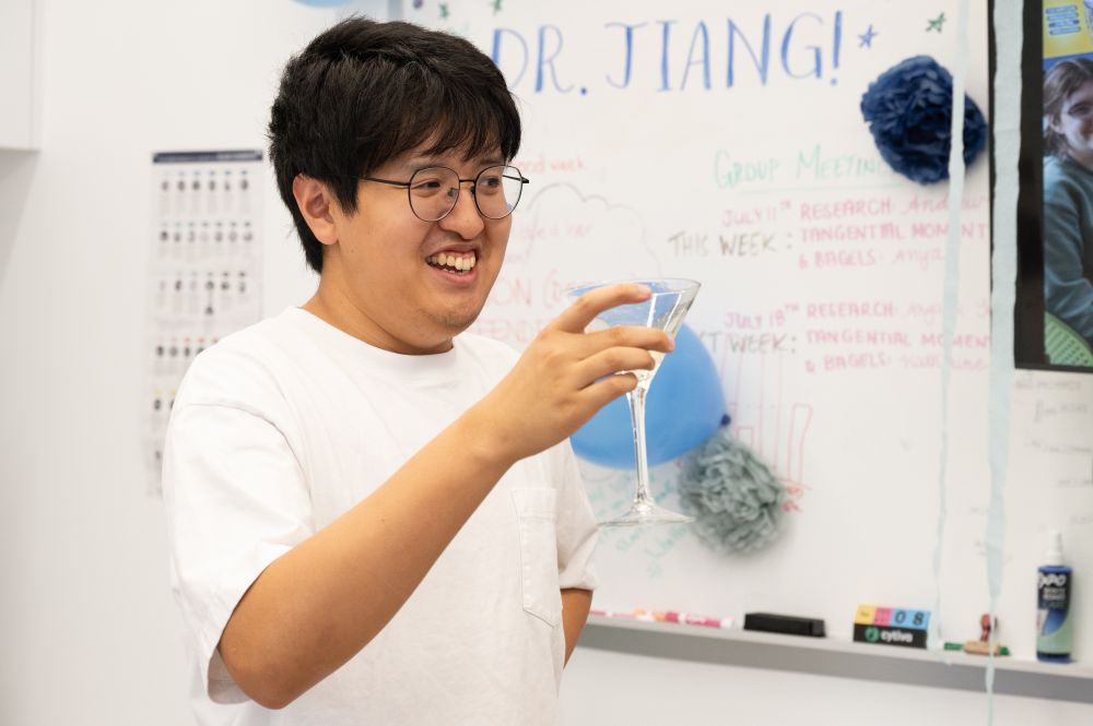 Dr. Jiang toasting his completed PhD defense!