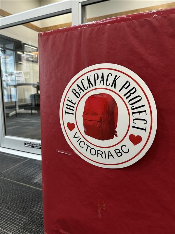 A red box with a red backpack and logo reading "The Backpack Project, Victoria BC"