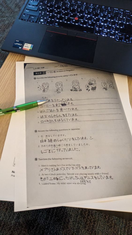 a very blurry, blown-up photo of a Japanese workbook printed out on letter-size paper. Kimberly has filled out most of the questions with a pen, but the questions themselves are really blurry.