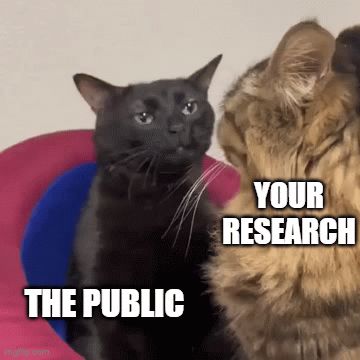 Fancy Cat, Ph.D., talks down to Public Cat as Public Cat looks on.