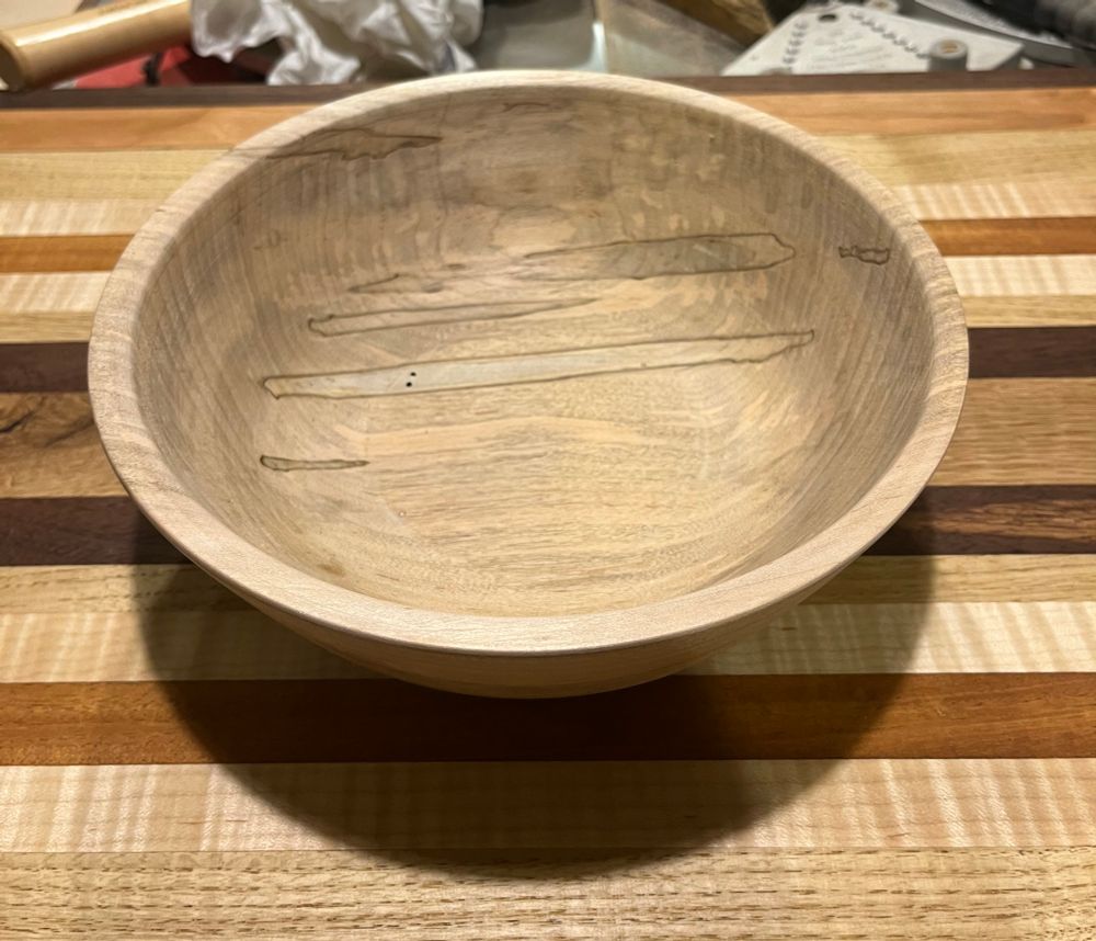 a turned wood bowl on a cutting board