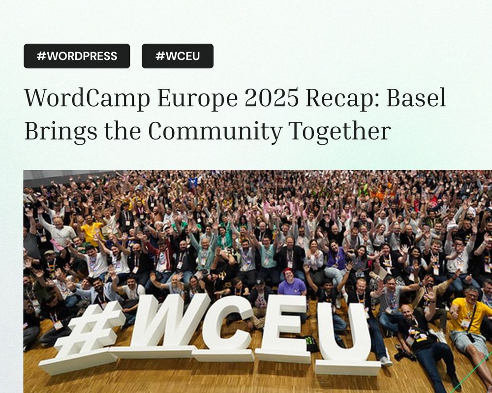 Large group photo of WordCamp Europe 2025 attendees celebrating in the Congress Center Basel, with hundreds of participants waving and cheering behind large white #WCEU letters on the wooden stage floor