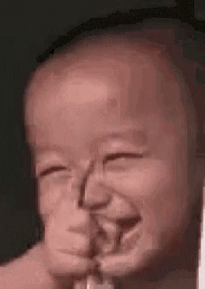 a baby is making a funny face with his eyes closed and his mouth open .