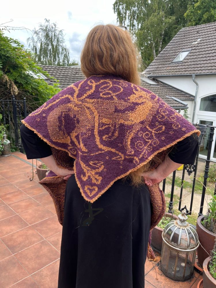 Me wearing my new Woodland Friends Shawl - rear view showing tapestry-like detail of foliage with fox in the undergrowth.
