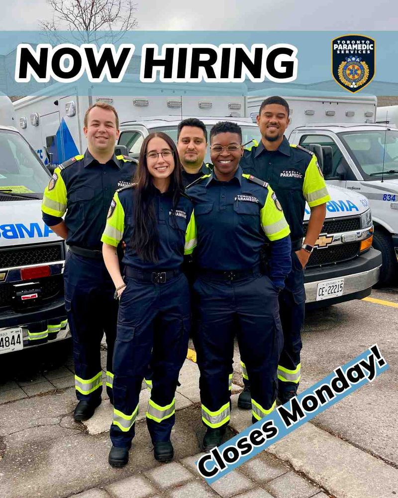 Group of five Paramedics standing in front of ambulances. Text reads: "Now Hiring. Closes Monday!"