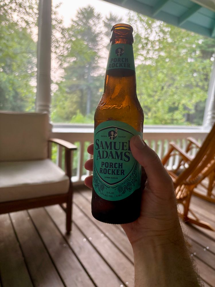 A bottle of Sam Adams Porch Rocker, being drunk on a porch