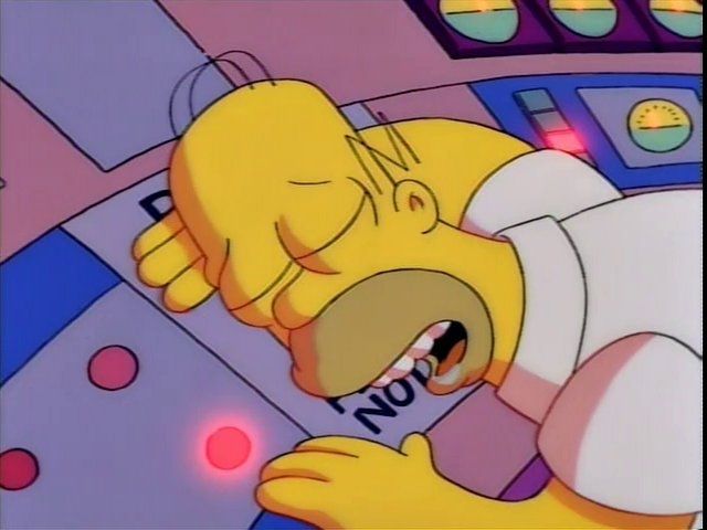 Homer asleep on the instrument panel, pressing the red button