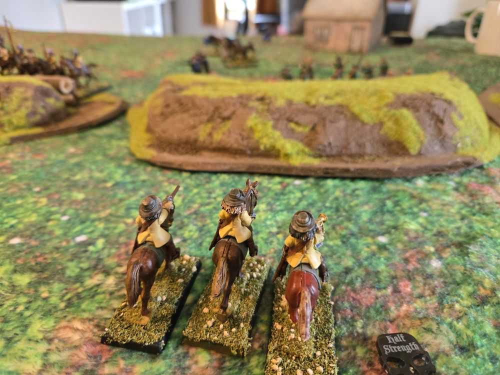 A battered cavalry unit charges the fieldworks