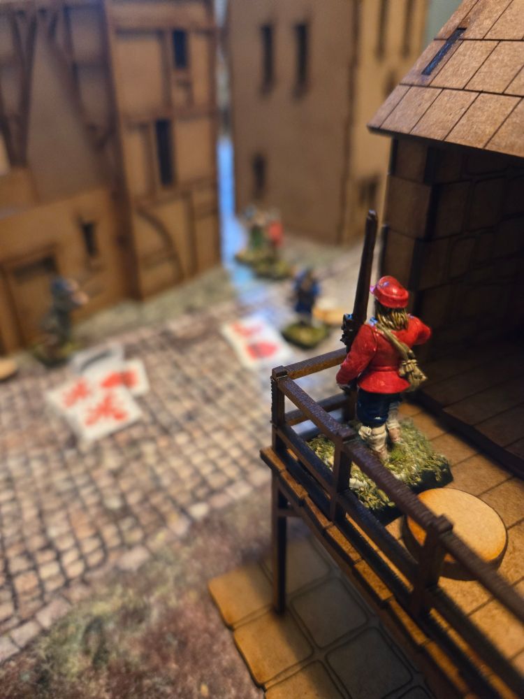 A man with a musket watches over a street from a balcony