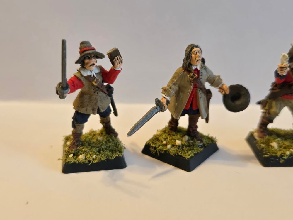 Two more Bloody Miniatures in red, one with a tiny Geneva Bible and sword and the other calling to the heavens 
