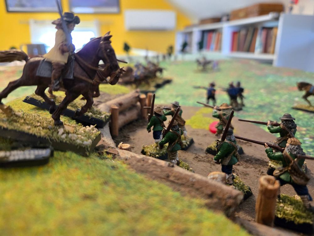 Horsemen crest the works and attack