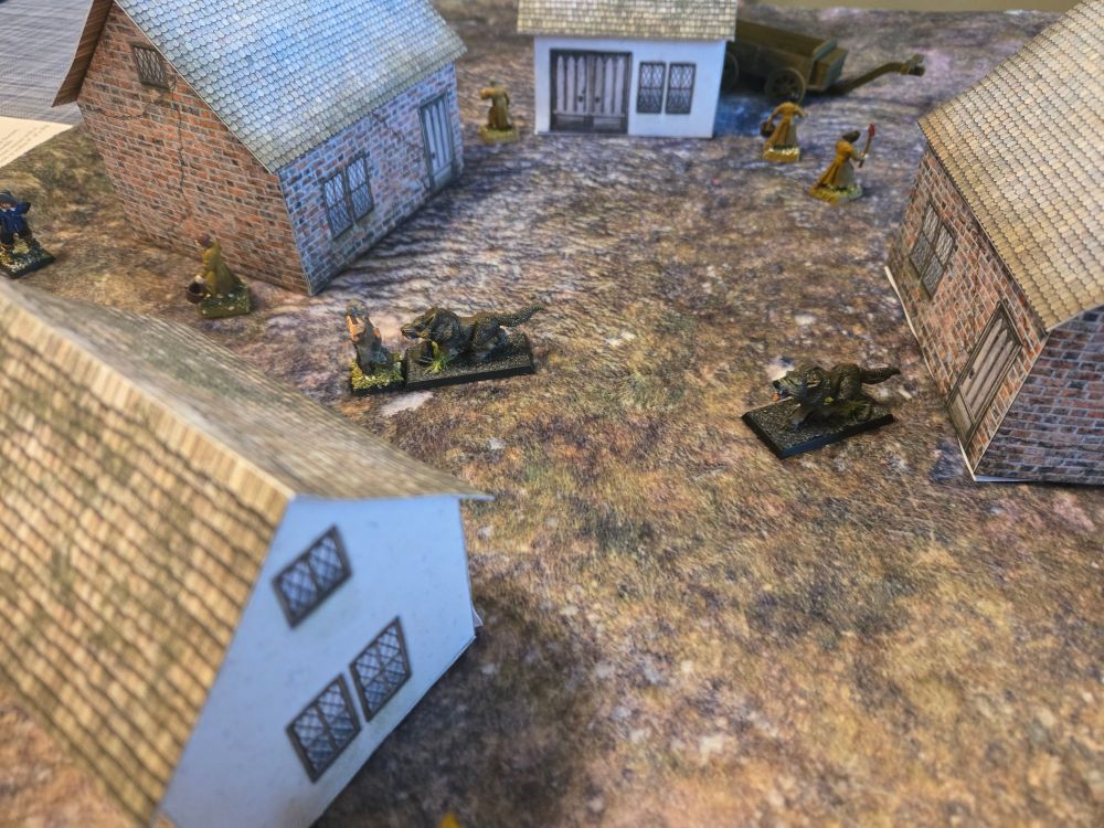 28mm wolves attacking a monster hunter while townsfolk flee among homes