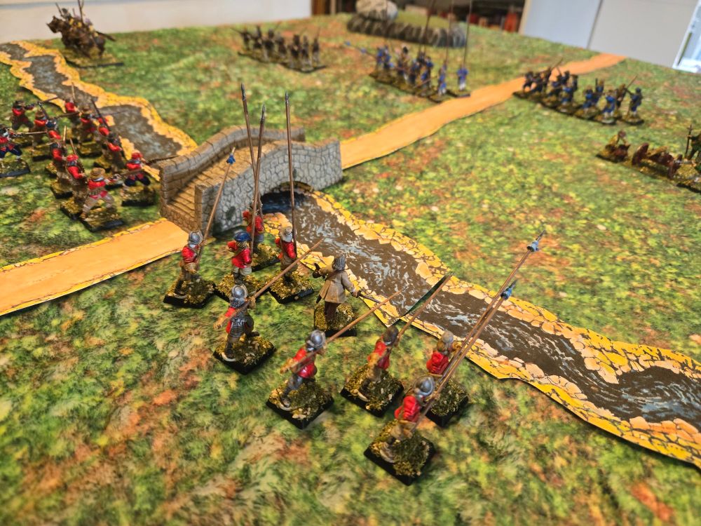 Red-coated pikeman guard a river crossing