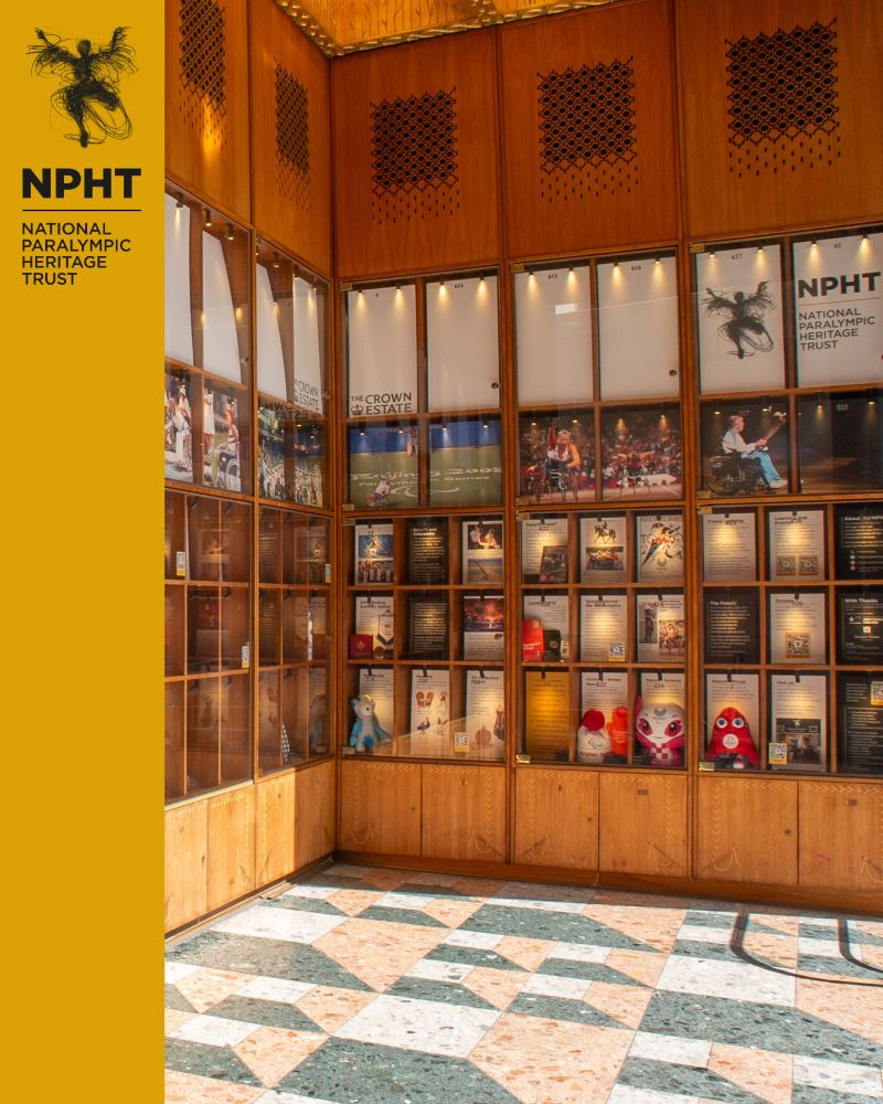 An image of the interior of the exhibition space, made up of lots of wooden shelves and with a tiled floor.