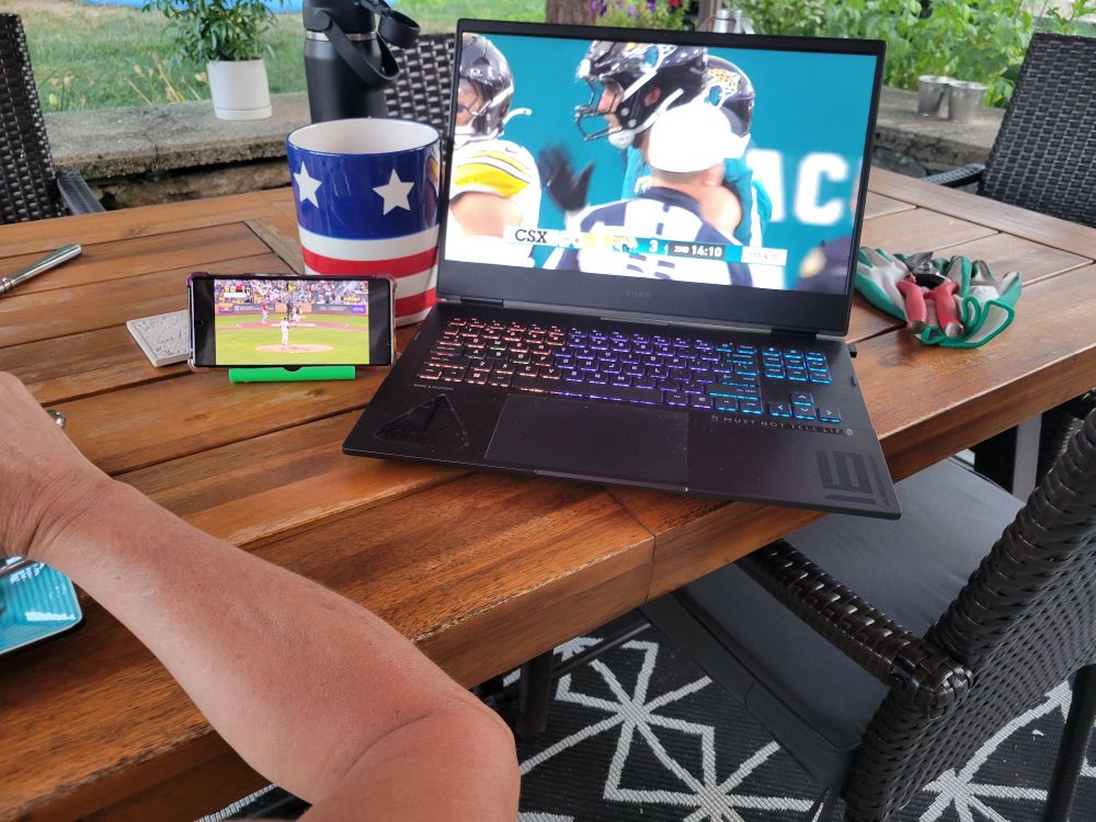Picture of laptop and cell phone with Pittsburgh sports teams playing.