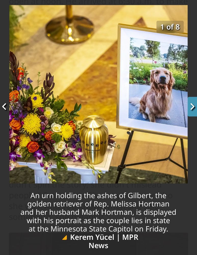 An urn holding the ashes of Gilbert, the golden retriever of Rep. Melissa Hortman and her husband Mark Hortman, is displayed with his portrait as the couple lies in state at the Minnesota State Capitol on Friday