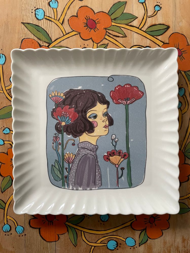 Ceramic square plate with a decal of a hand drawn portrait of a lady with flowers