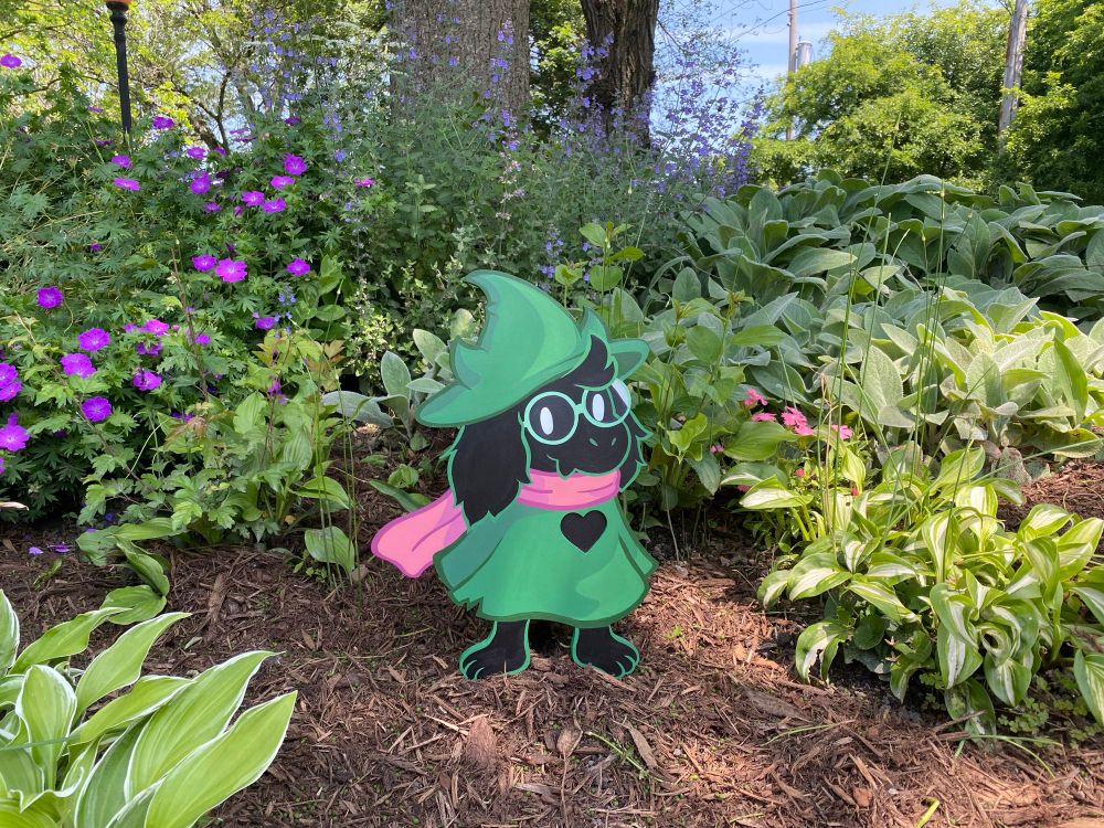 Wood Ralsei in a field of flowers 