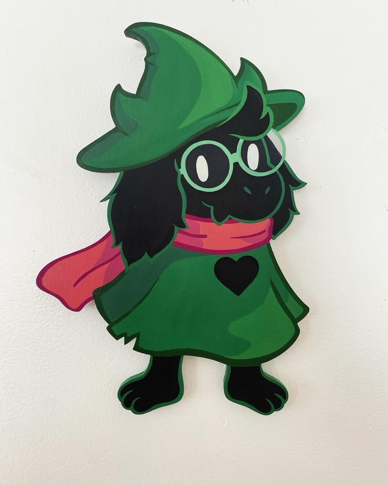 A 14 inch tall shaped wood art piece of Ralsei from the game Deltarune 