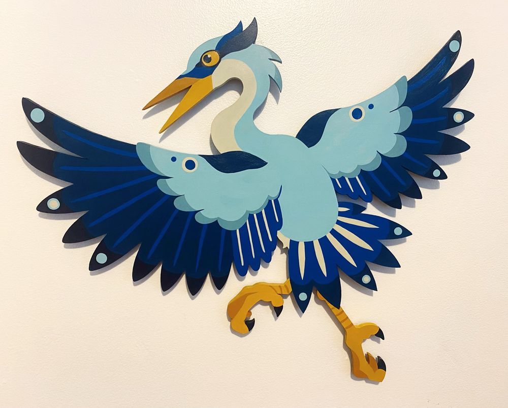 A piece of art showcasing a heron flying in the air 